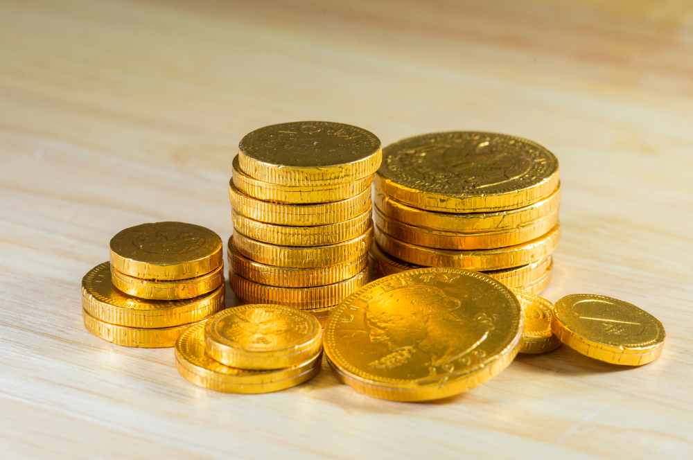 Stacks of gold coins on a wooden surface — Coin Buyers in Abilene.